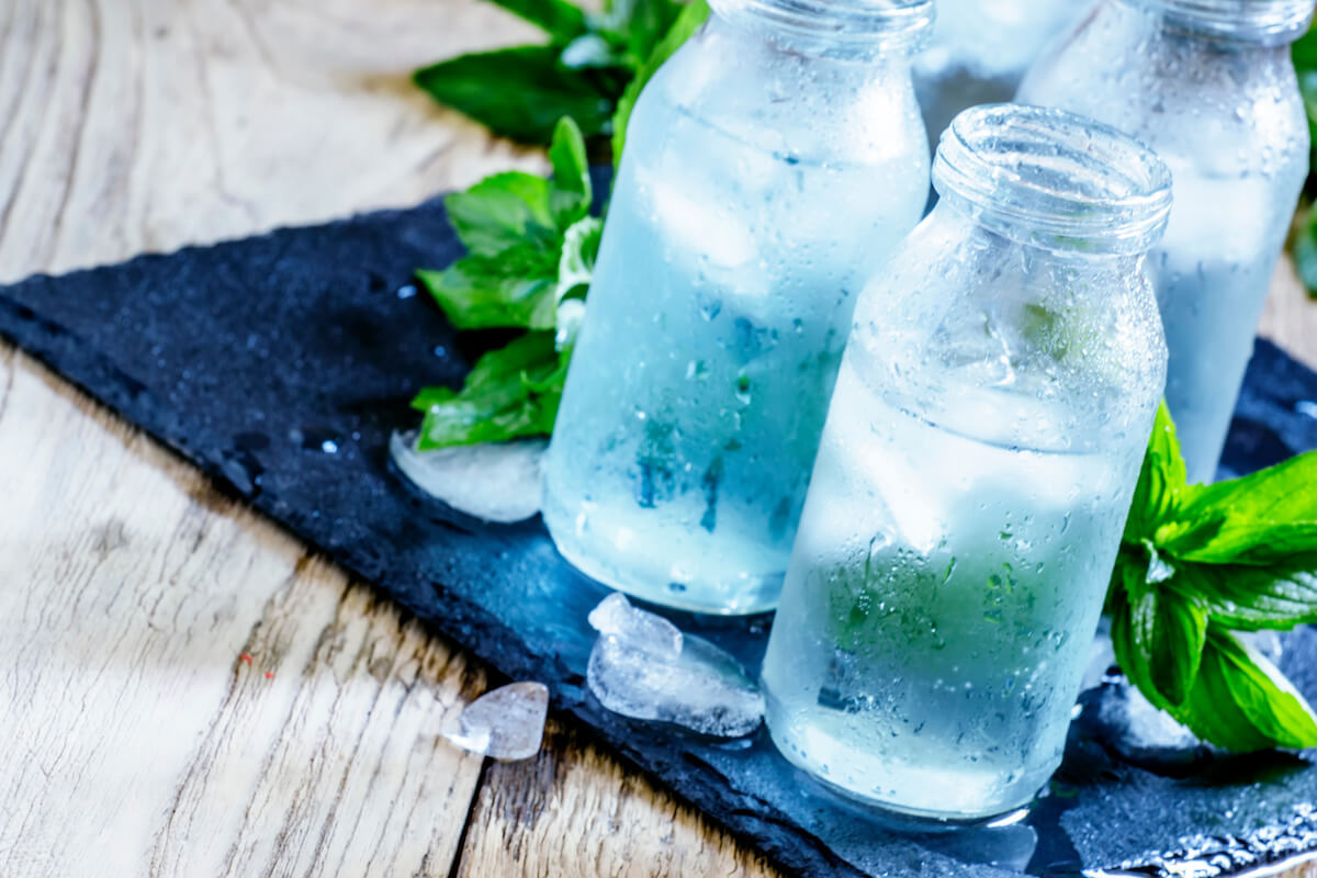 Very cold mineral water with ice in a misted glass bottles