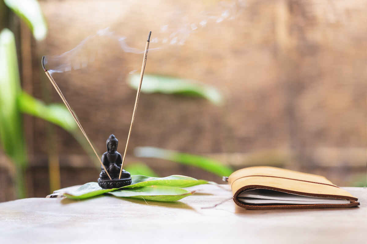 Journal and incense on desk for reflecting