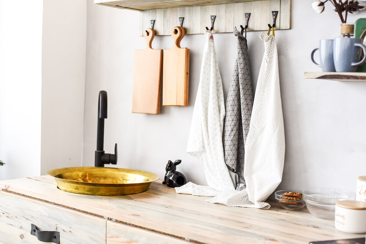 Kitchen setup with sink, kitchen towels and dishes 