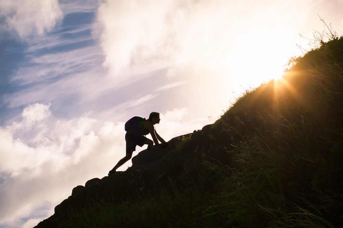 Man climbing up a mountain