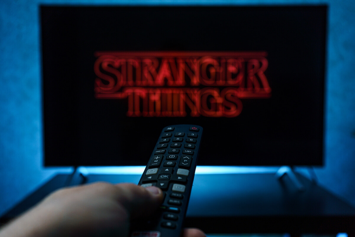 Watching Stranger Things television show on TV.