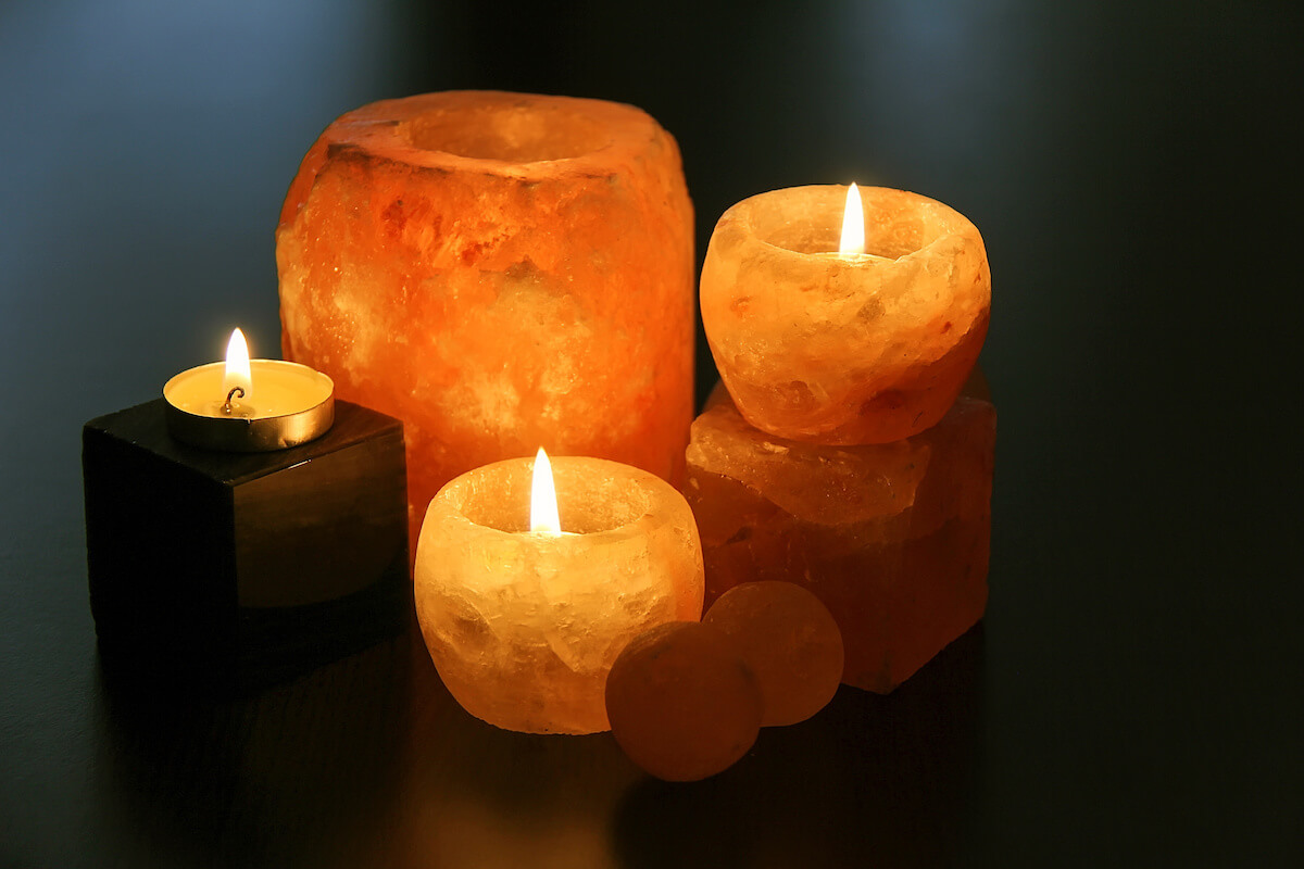 Himalayan salt candles holders on the dark desk.