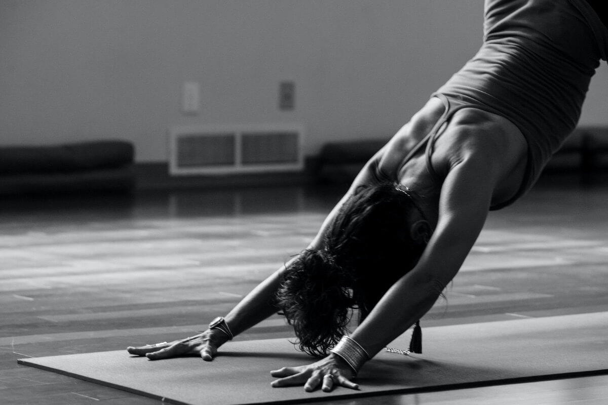 A black and white photo of a woman doing a yoga post