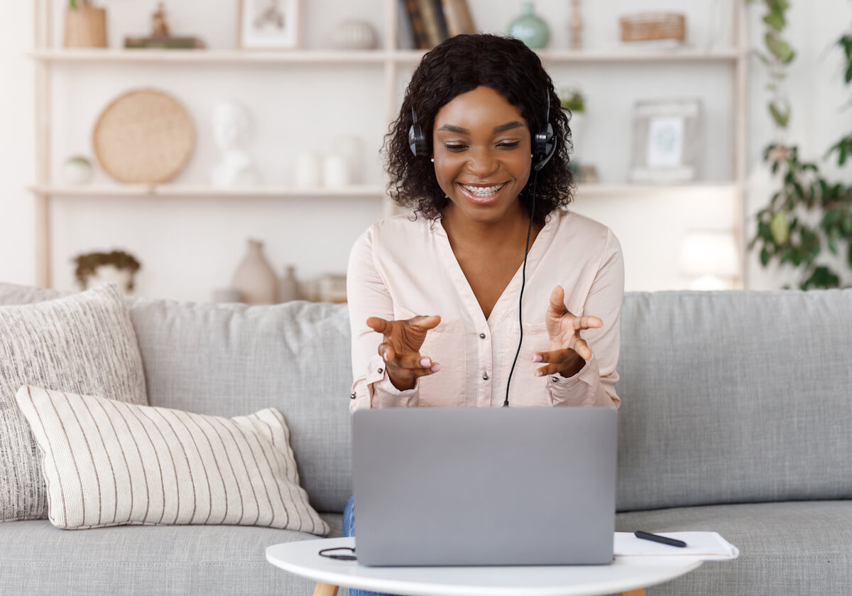 Smiling black female tutor having video call with student