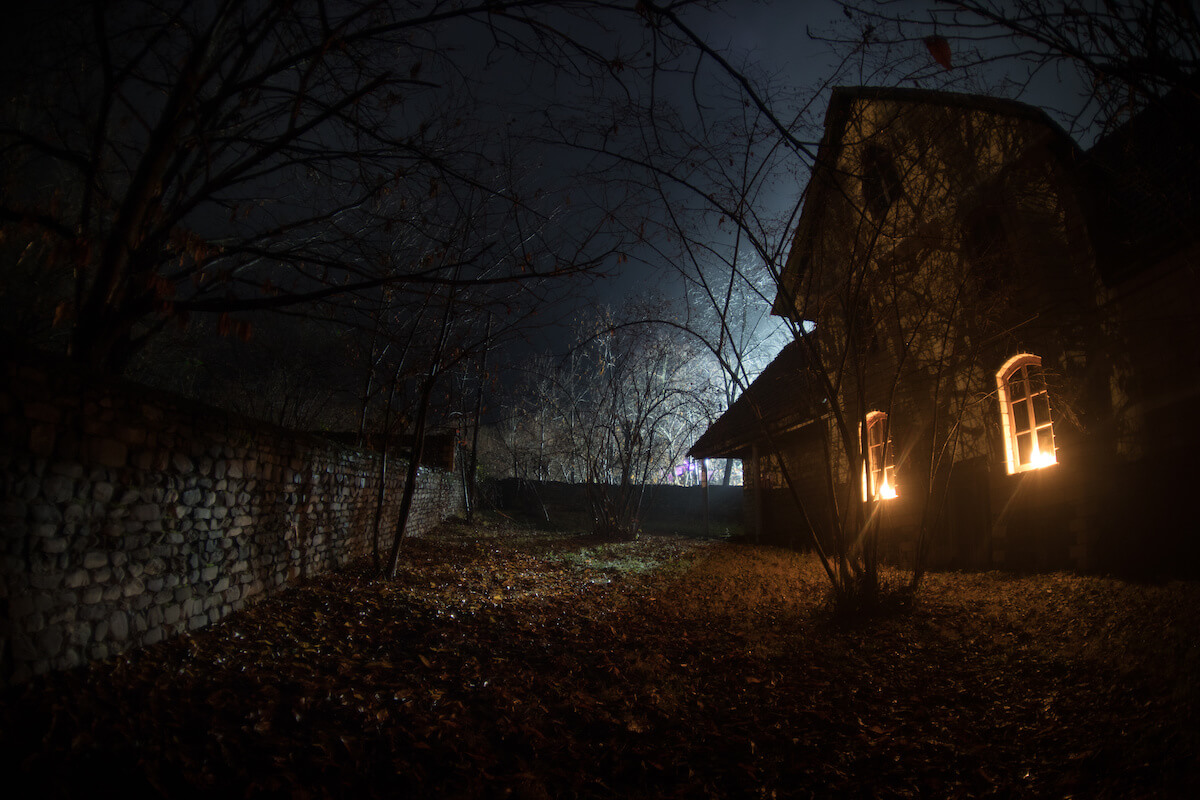 Old house with a Ghost in the forest at night or Abandoned Haunted Horror House in fog