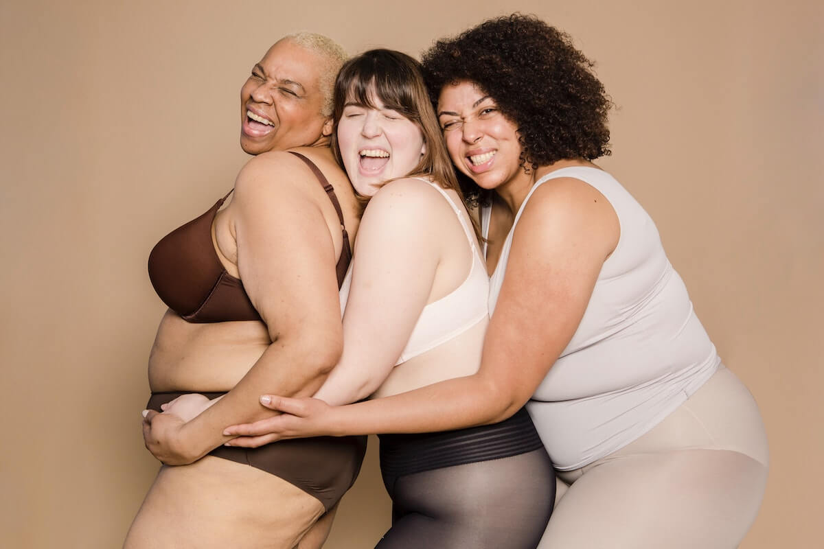 Three plus-size models laughing and having fun