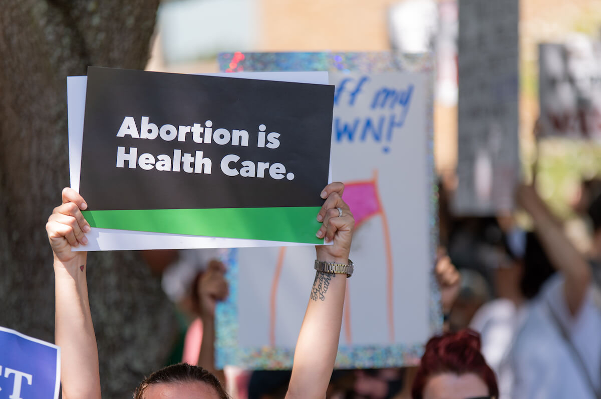 Woman Holding a "Aborton is Health Care." Sign at the ‘Bans Off Our Bodies’ Protests Defending Abortion Rights