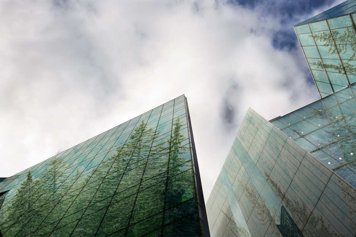 Sustainable, green energy city, urban ecology concept and modern business buildings surface covered in forest