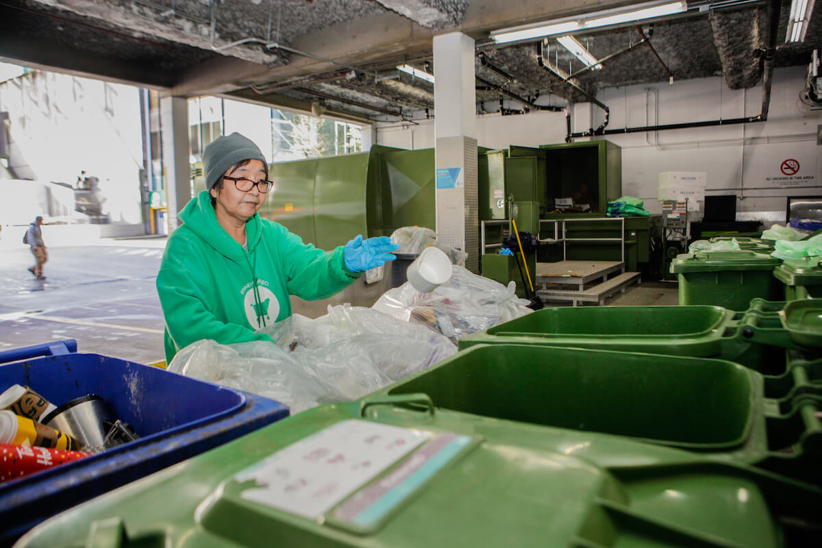 A binner hard at work sorting waste and helping with diverting items from landfills.