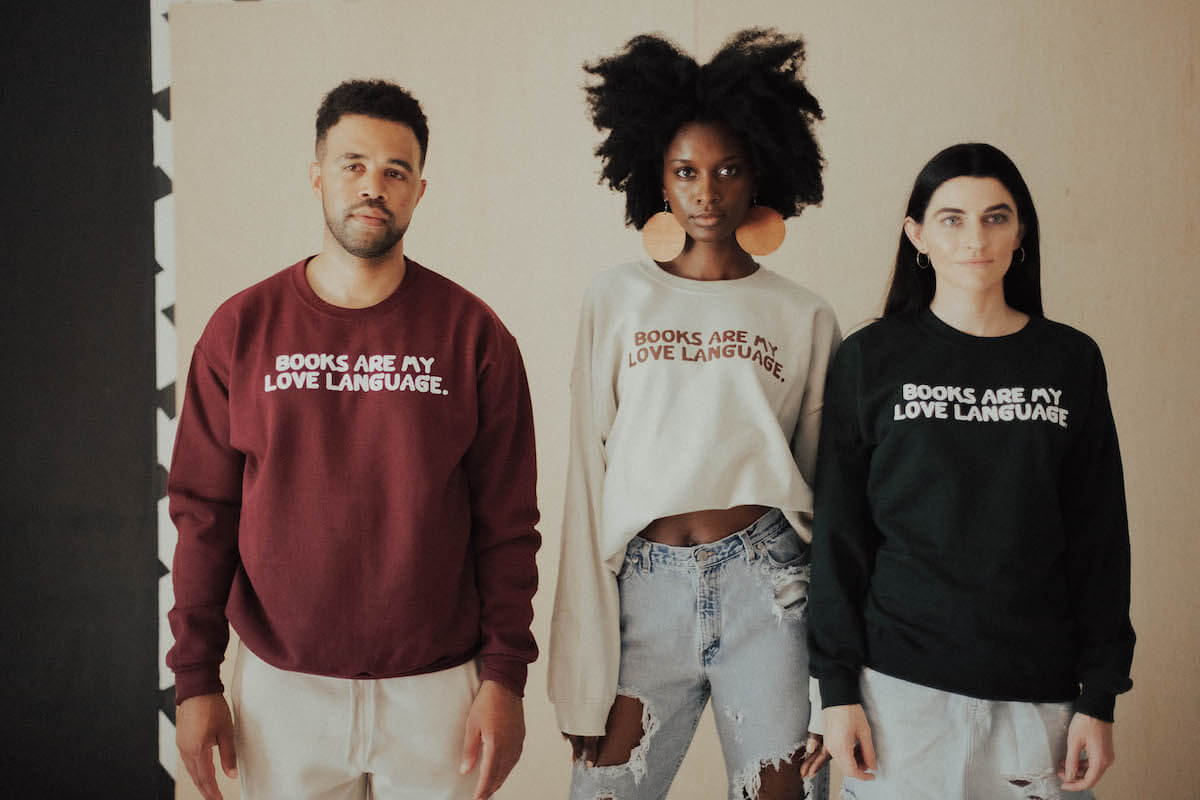 Nia-Tayler Clark, middle, models BLACKLIT’s “love language” sweatshirt with a couple other models. 