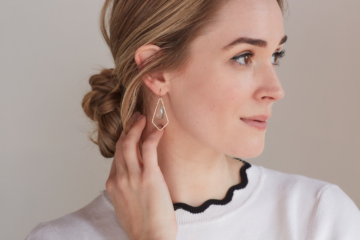 A model wearing jewelry from Kind Karma Company.