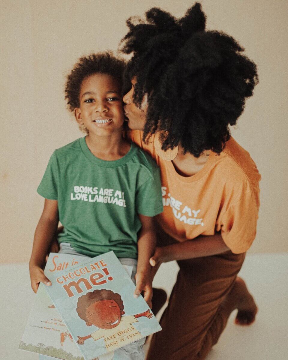 Nia-Tayler Clark with her son showing books. 