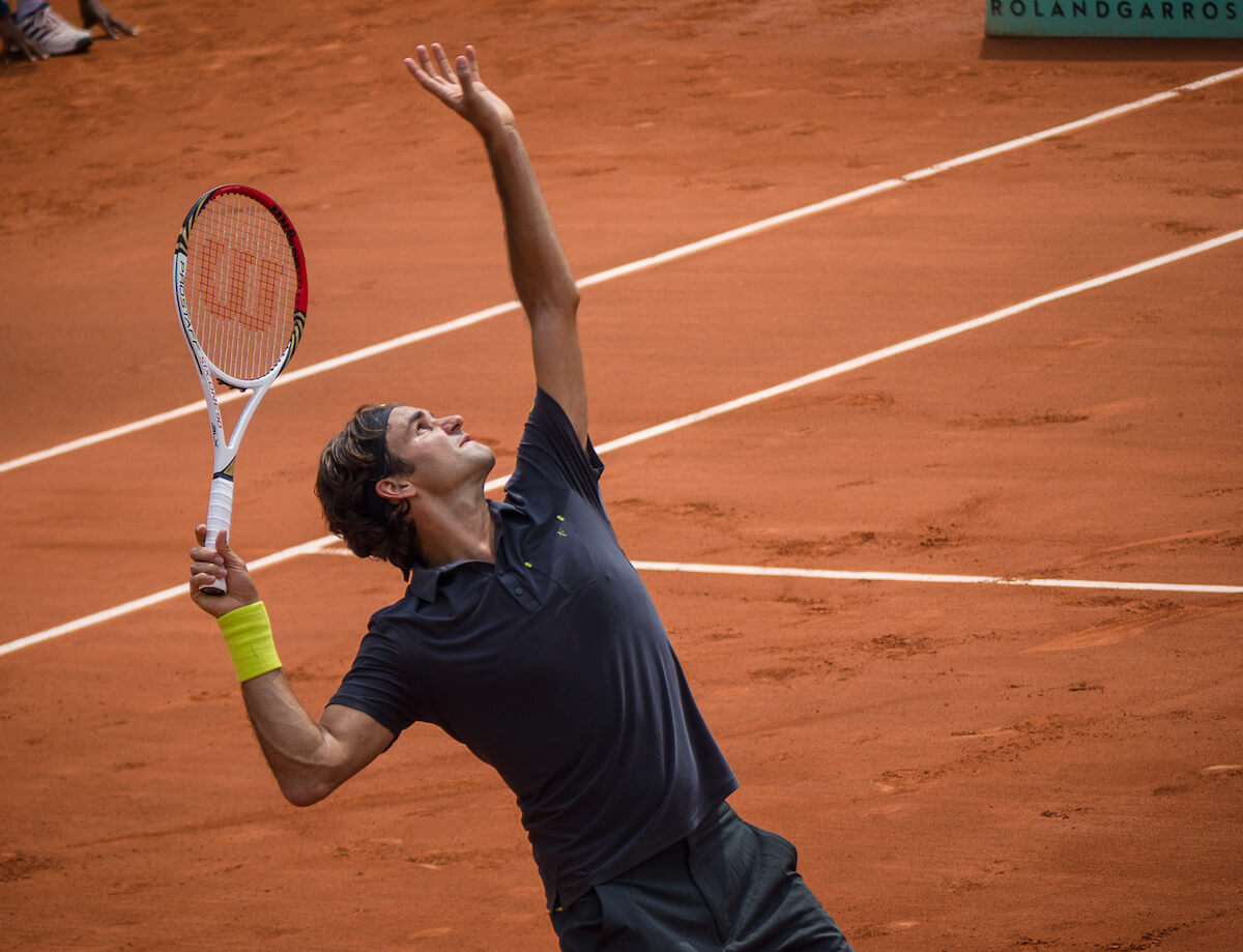 Roger Federer doing a serve during a tennis match.