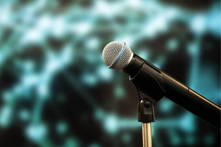 Close up of microphone with blue and black background