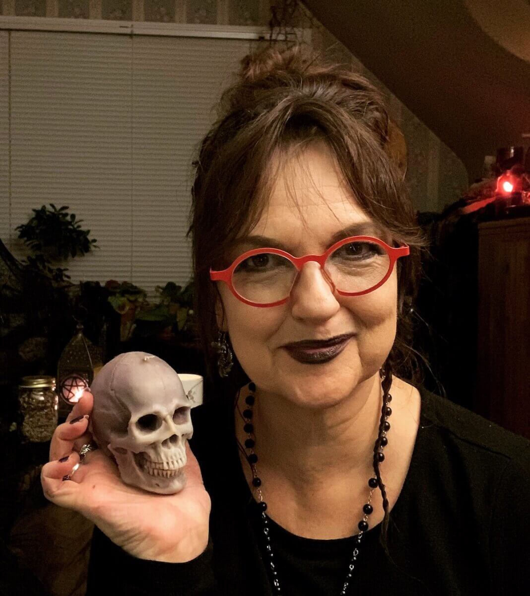 Monica Bodirsky, a professional tarot reader and artist, holding a crystal skull.