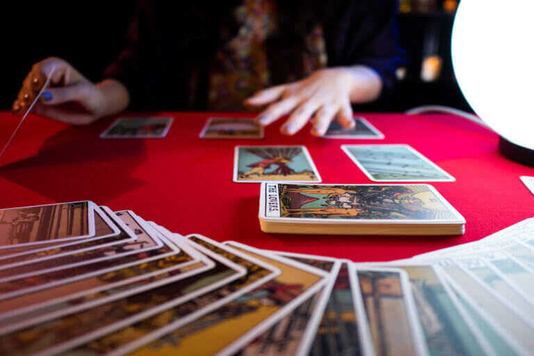 Person using tarot cards on a table
